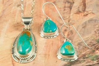 Genuine Manassa Turquoise set in Sterling Silver. Beautiful Pendant and Earrings Set. This Turquoise is also referred to as King�s Manassa Turquoise. The Manassa Turquoise mine is located in Manassa, Conejos County, Colorado. Created by Navajo Artist Phillip Sanchez. Signed. Free 18" Sterling Silver Chain.